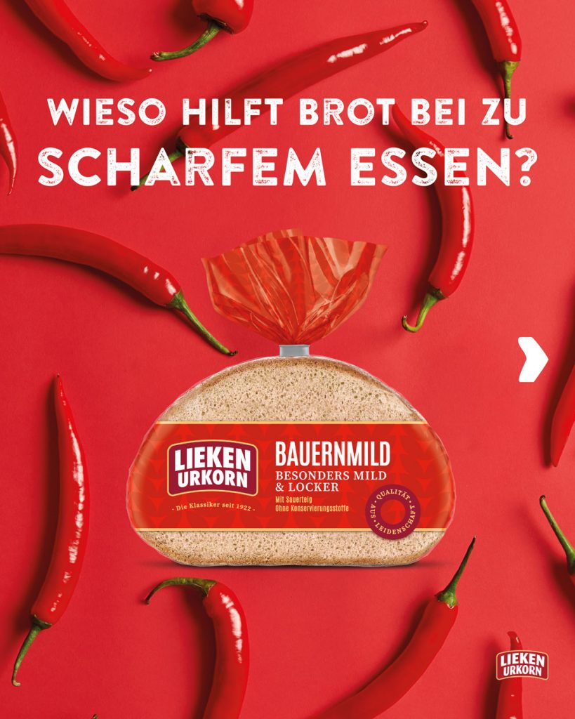 Eine Brotverpackung liegt auf rotem Hintergrund, darum sind Chillischoten verteilt. Darüber steht: "Wieso hilft Brot bei zu scharfem Essen?"